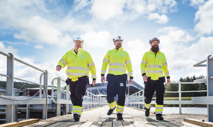 Engineers walking along a bridge at a Uniper hydro plant in Sweden