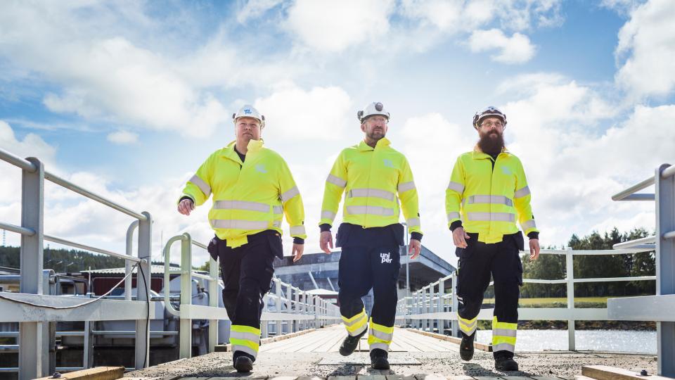 Engineers walking along a bridge at a Uniper hydro plant in Sweden