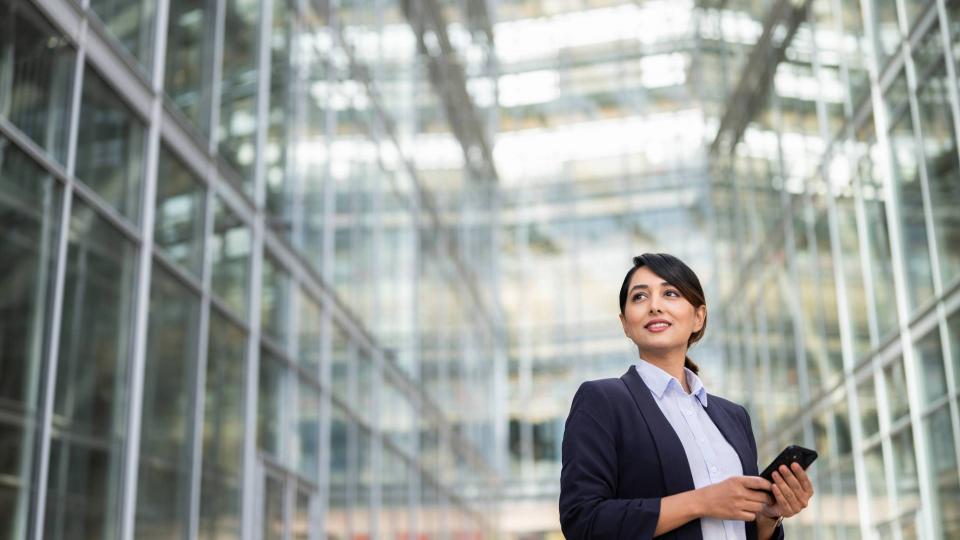 Businesswoman at the entrance of a glass building